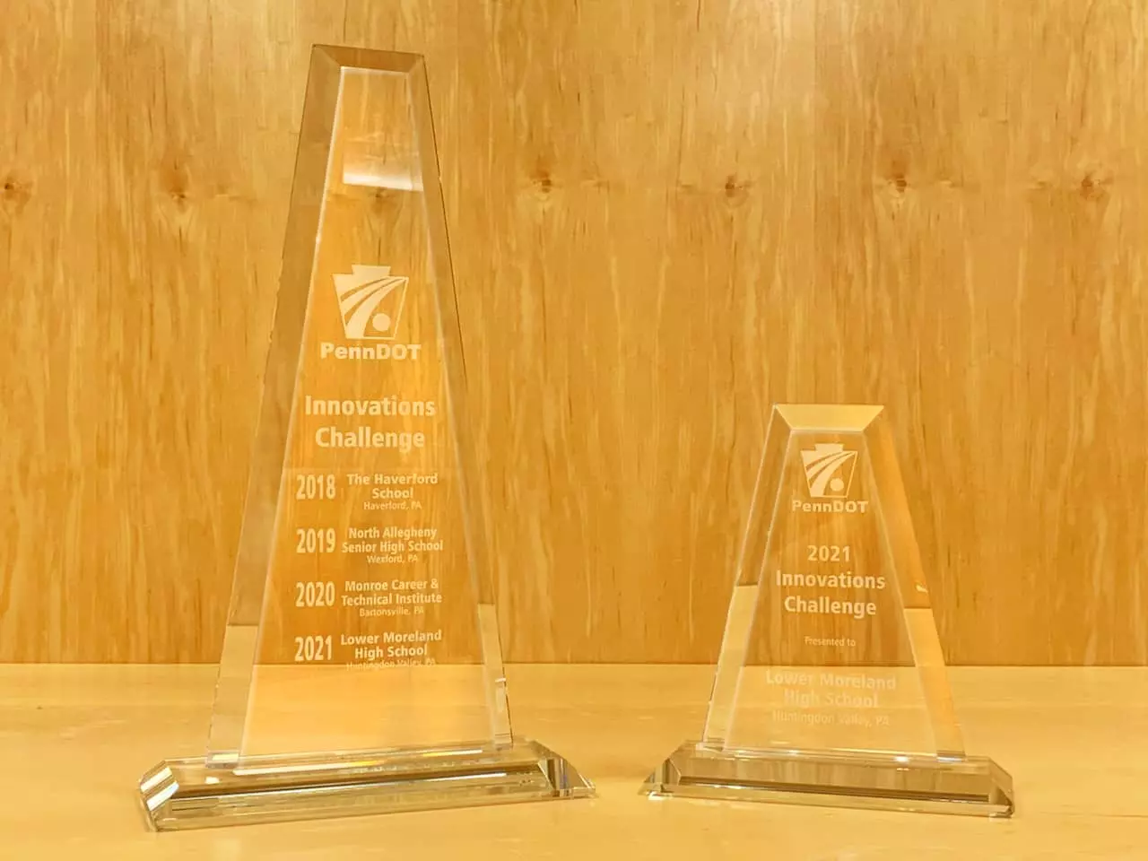 Innovations Challenge traveling trophy showing past winners, next to the Lower Moreland High School 2021 Innovations Challenge trophy.